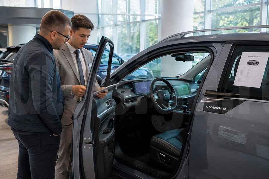 Покупатель осматривает комплектацию автомобиля Changan в салоне